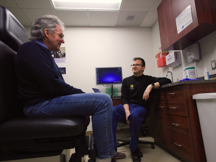 patient talking to doctor in doctor's office
