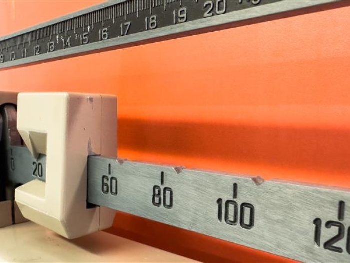 scale close up of numbers orange wall
