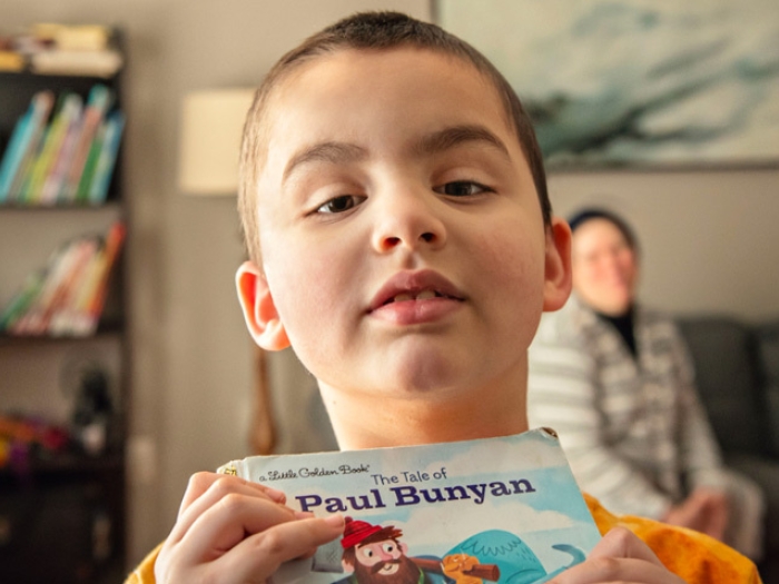 boy holding book 