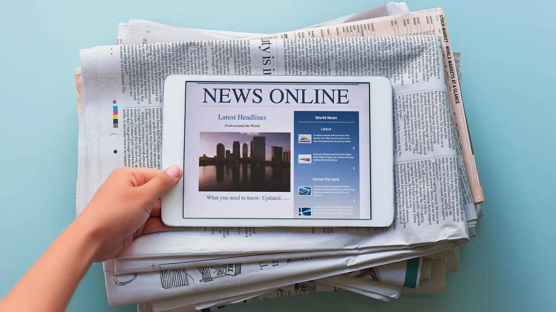 News Tablet on top of newspapers
