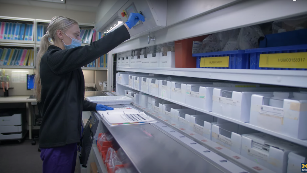 Photo of research pharmacy staff working in front of large ID storage