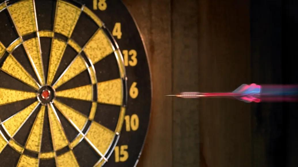 close-up of dart hitting dartboard