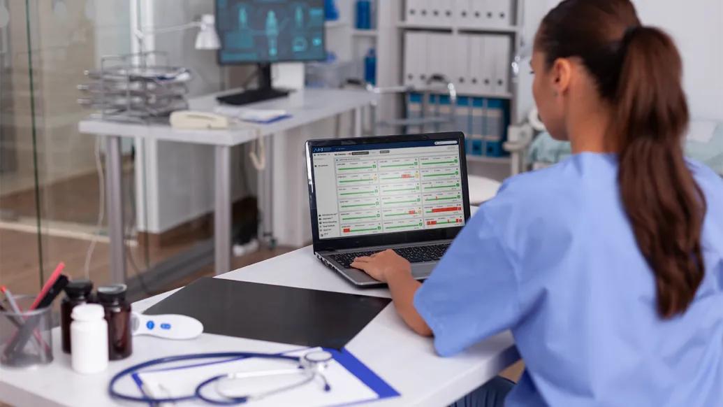 Nurse viewing AHI interface displayed on a laptop computer monitor.
