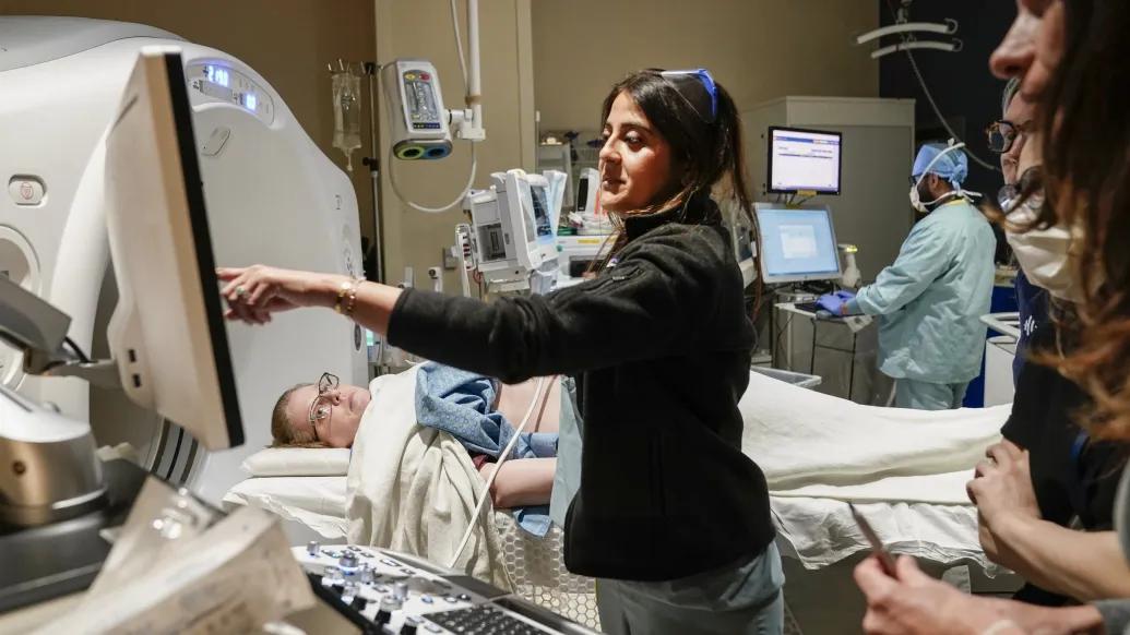 Patient receiving histotripsy treatment with health care providers using equipment