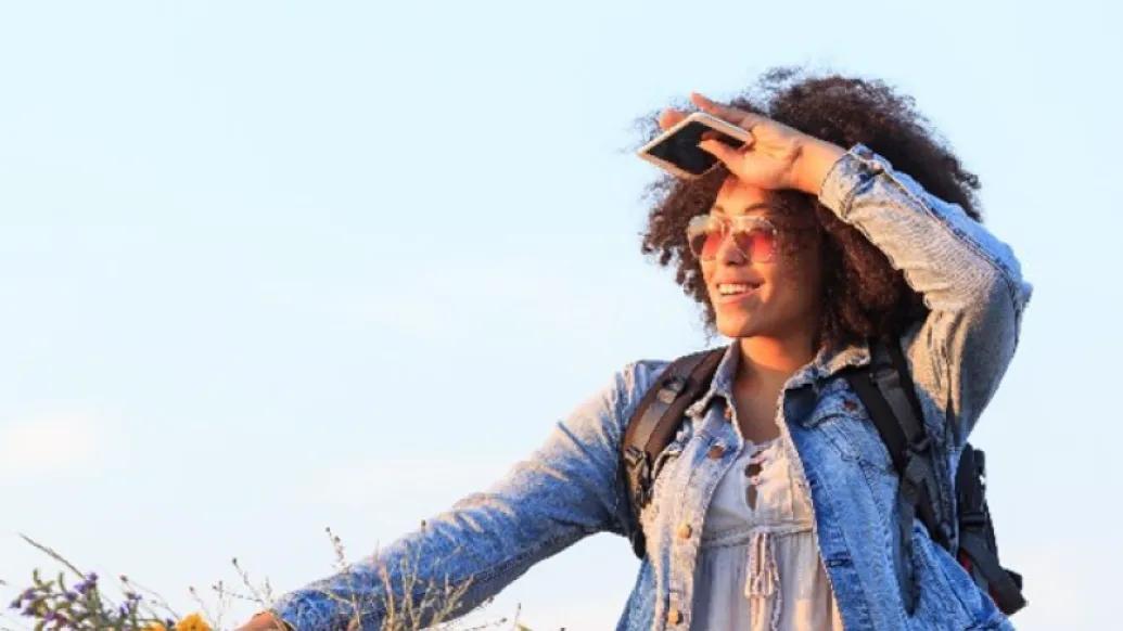 woman outside smiling looking into the sunlight