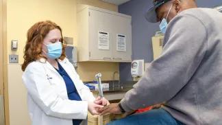 photo of Dr. Melissa Elafros checking a patient for signs of diabetic neuropathy