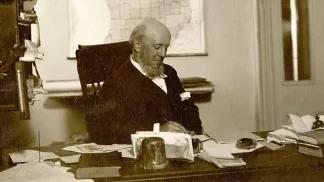A man sitting at his desk in 1871