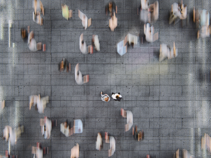 crowded blurred people walking in city streets