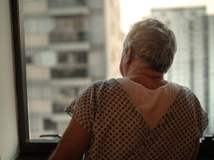 man patient looking out window