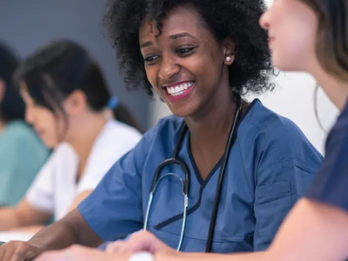 Image of female study team member sitting in educational session 