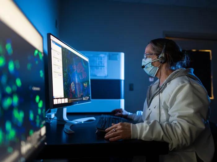 researcher working in lab with two monitors