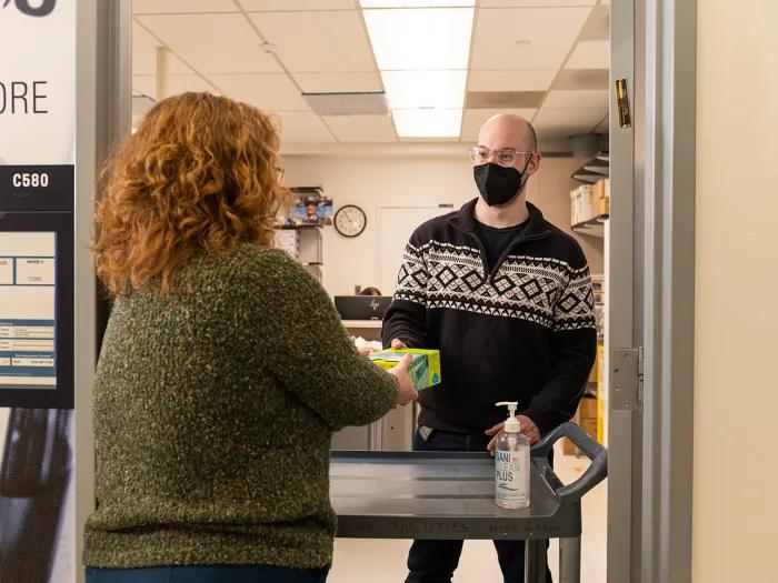 two people exchanging items at the Store