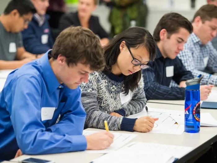 education course participants writing notes