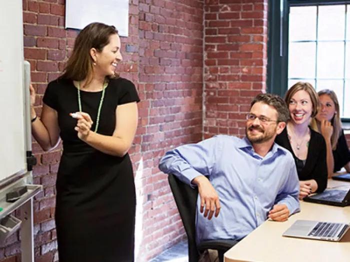 woman pitching idea to three other people