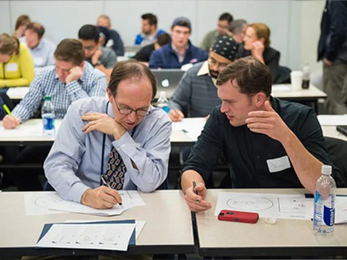 two participants in a seminar discussing topics