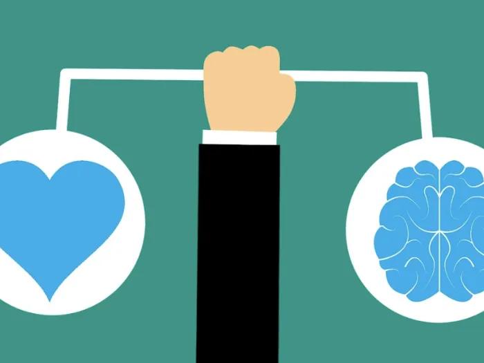 Ilustration of a hand holding a heart and a brain like doing some balance.