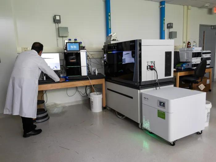 scientist using mass spectrometry technology