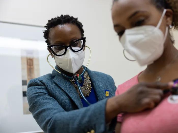 doctor listening to heart of patient 