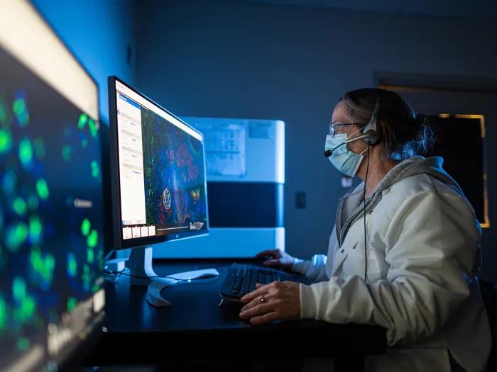 woman working in lab at computer screens
