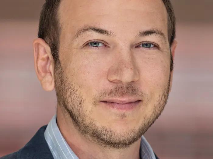 headshot of Adam Courtney