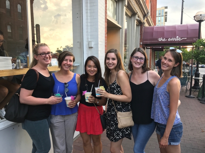 Residents smile for a photo outside