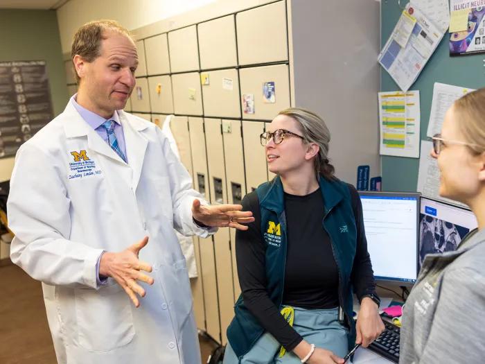Photo of faculty talking to study team