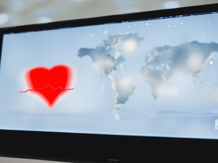 Computer screen with heart and world map