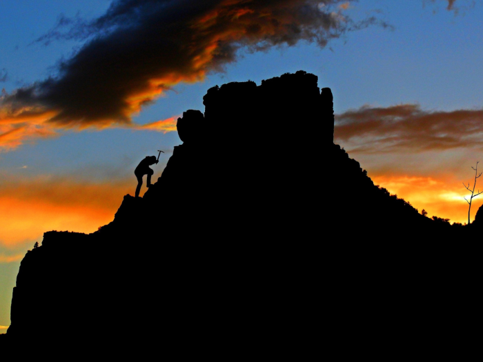 climber on a rocky outcrop at dusk