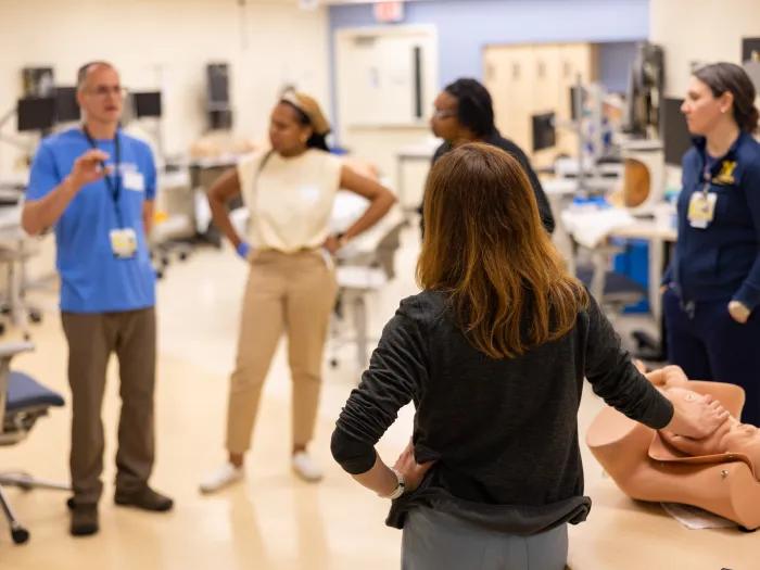 A group of students listening to a lecture in an exam room