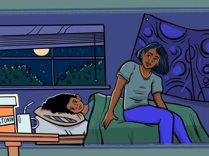 mom sitting at end of bed with child laying down moon outside purple bedroom green covers tan pillow