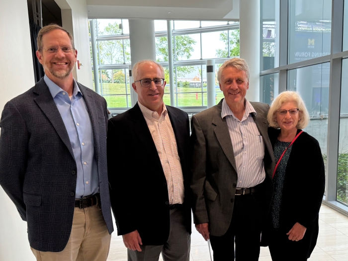 Four smiling people at mentorship forum