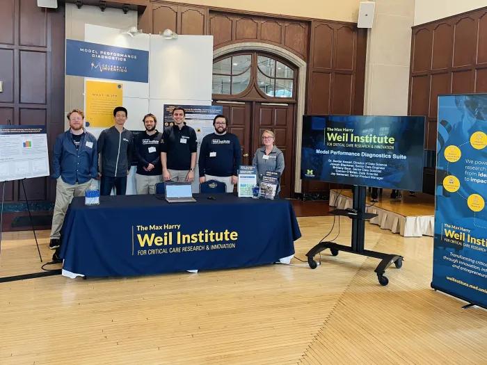 Members of the Weil Institute Data Science and Commercialization teams stand at their table display during Celebrate Invention 2023.