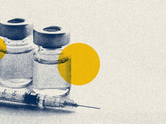 Vials in blue and yellow with syringe