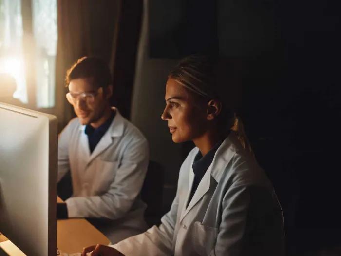 Two Researchers Watching Educational Videos on Computer