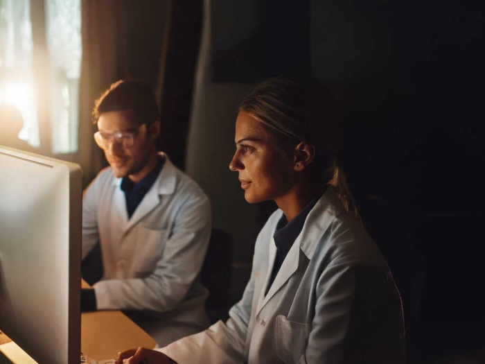 Two Researchers Watching Educational Videos on Computer