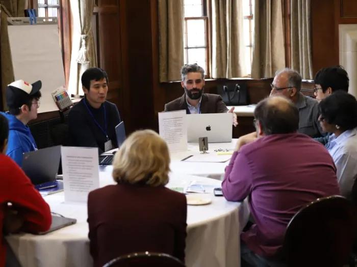 Group of people sitting at a table in a conference room