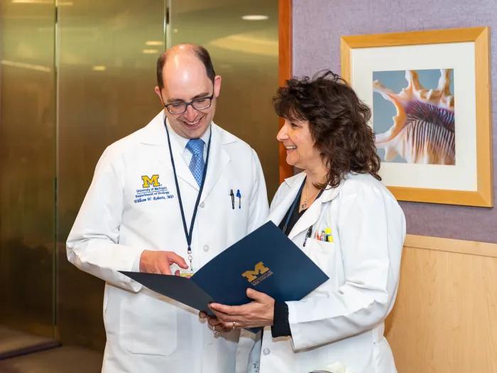 Two Endourology physicians look over a folder