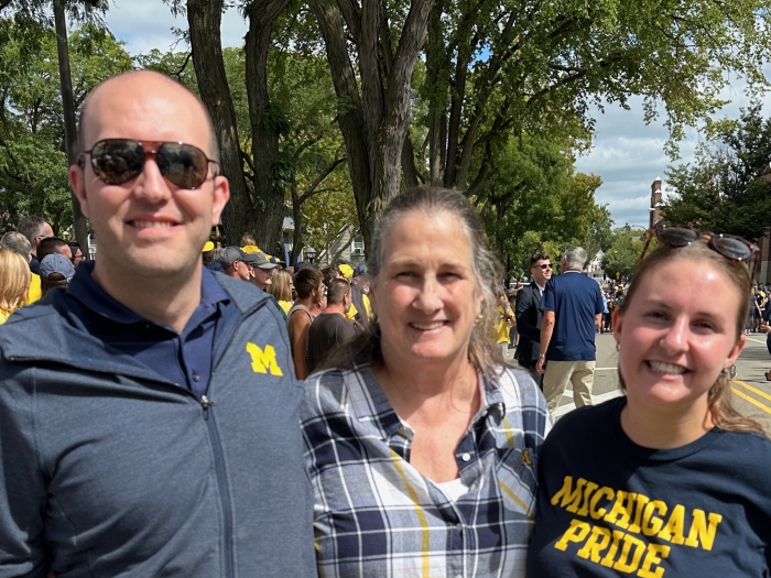 Smiling photo of the Cozads on a sunny day at a campus event.