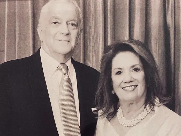 a couple in black and white standing side by side 