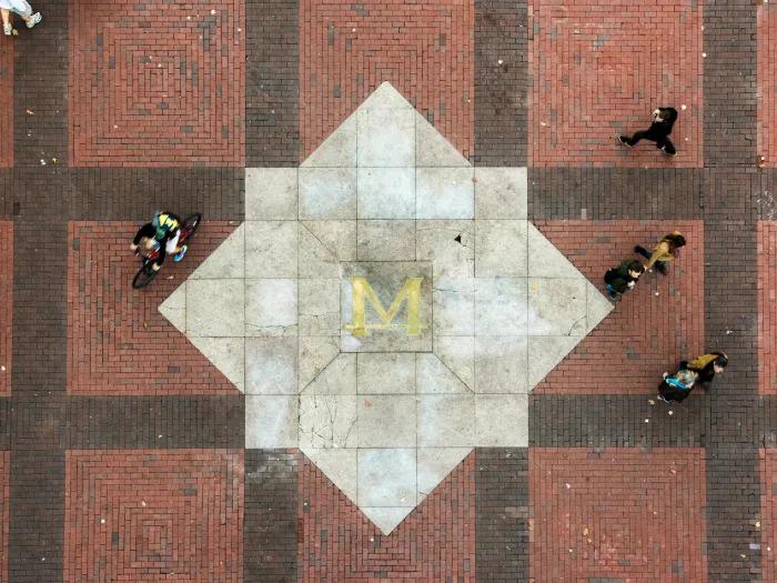People walking and biking across the U-M diag
