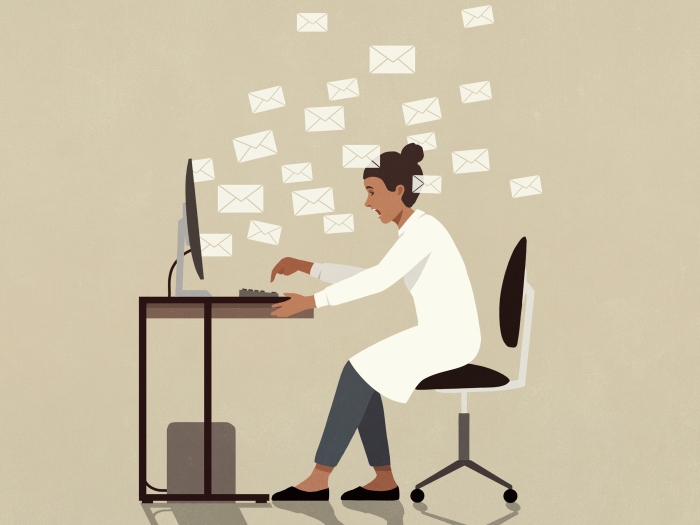 doctor at desk computer stressed and emails floating all in the air