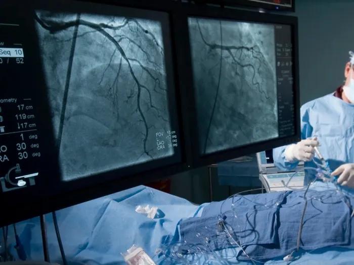 up close doctor in hospital with cardiology close up scans on monitors