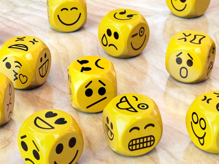 yellow dices with different emotional faces on each side