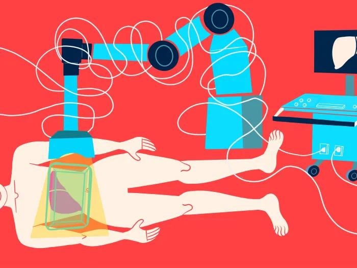 red background person laying on ground with machine over looking into body organs appearing on screen