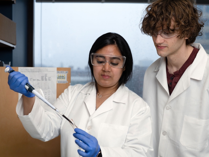 Indian female and white male lab technician work together in the lab