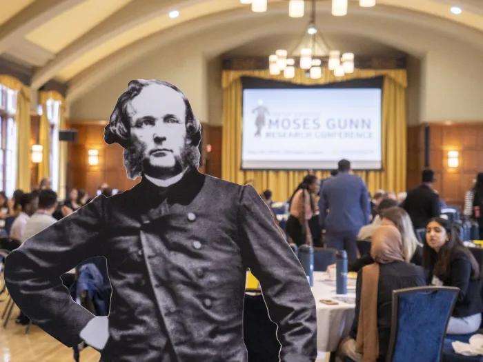 Black and white cutout of Moses Gunn in front of a conference space with several tables
