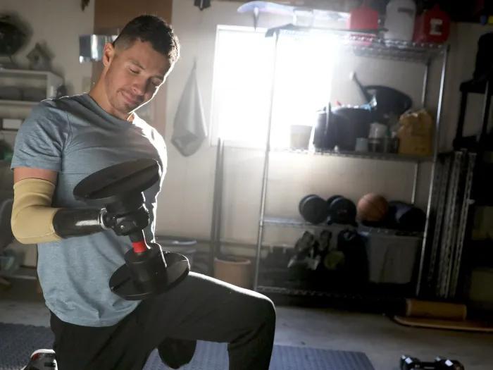 man lifting weight on knees in home gym