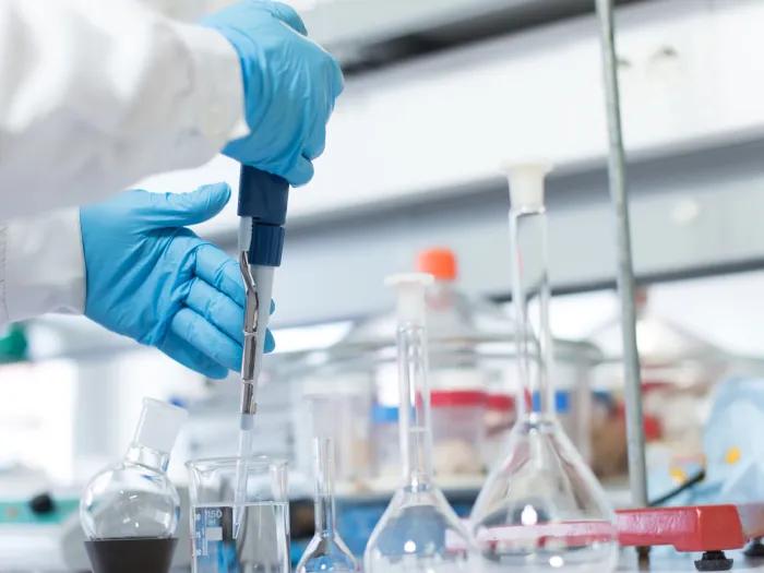 Close up of someone using equipment in the lab