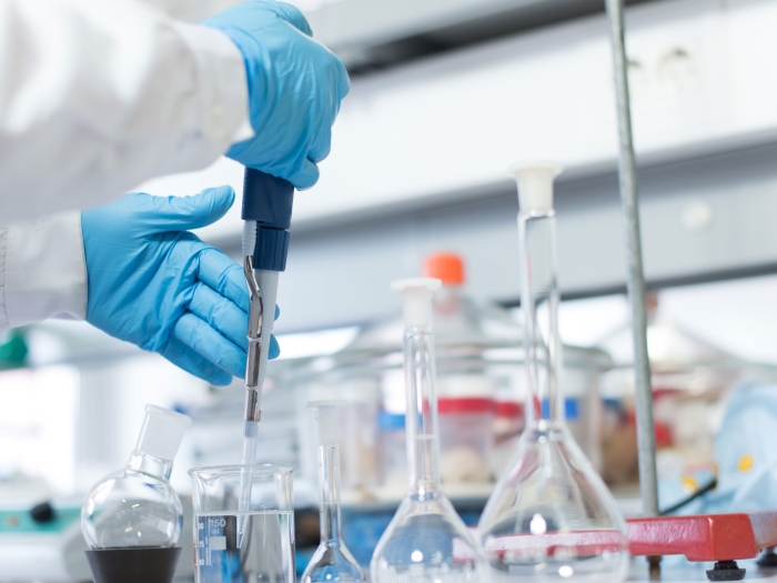 Close up of someone using equipment in the lab