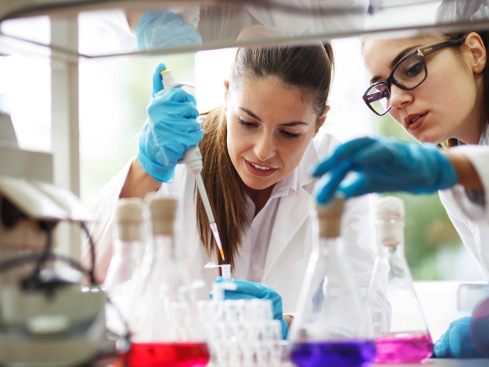 Lab members working with equipment in the lab